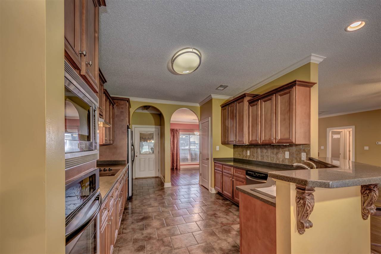 8 Eagle Trace Road Covington, TN 38019 - Photo 10 of 25 Great Space With Pantry, Corian Countertops And Open To Informal Breakfast/Dining Area For Family and Entertaining Overflow.