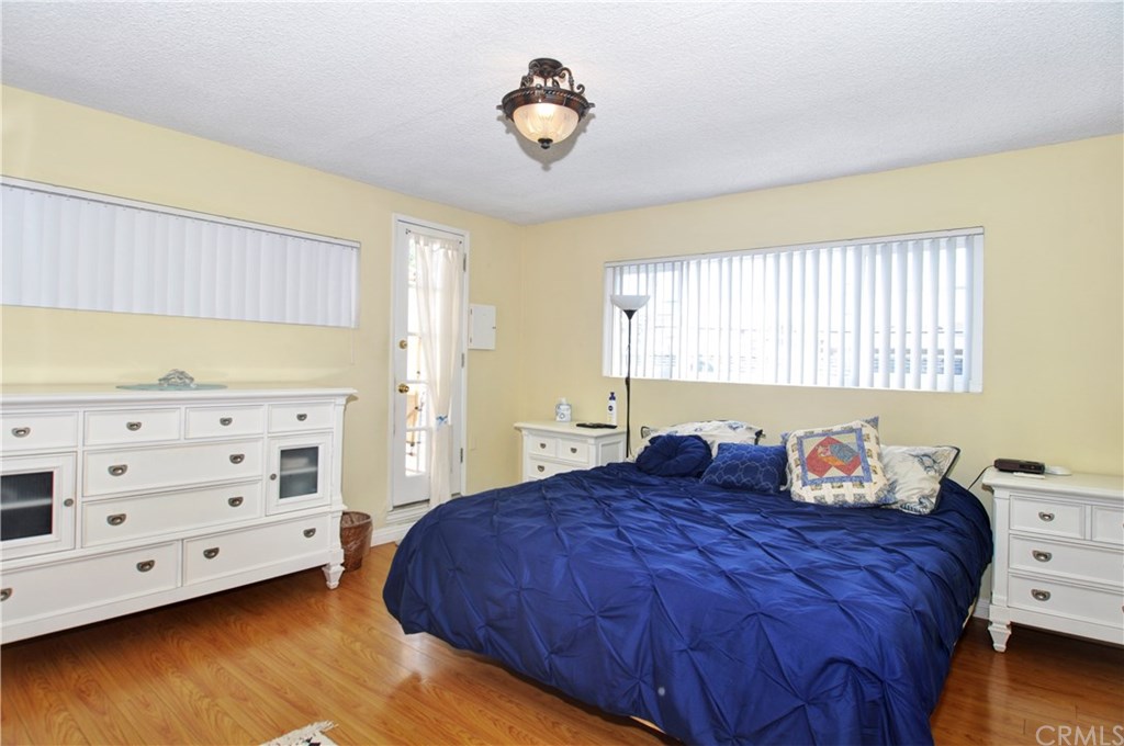253 17th Street Seal Beach, CA 90740 - Photo 26 of 36 Light and Bright, with laminate flooring and a side door leading to the private deck