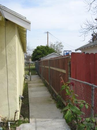616 R Street Bakersfield, CA 93304 - Photo 12 of 14 Concrete path surrounds perimeter of property.