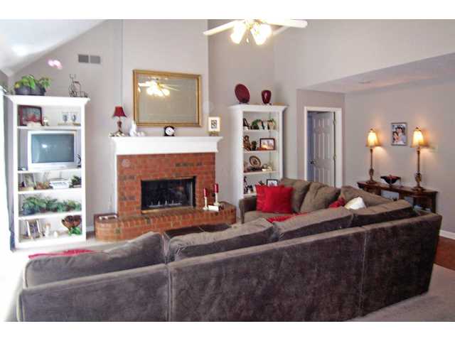 8751 Raspberry Lane Memphis, TN 38016 - Photo 6 of 24 Another view of the living room, you can see the high ceiling and the fireplace for colder days
