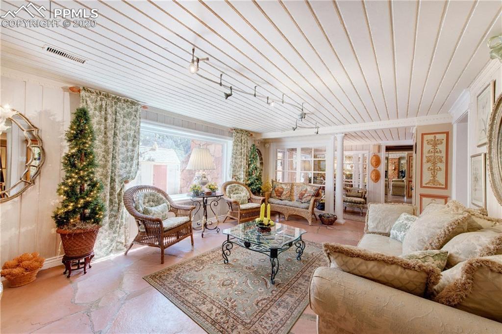 7955 Highway 24 Cascade, CO 80809 - Photo 19 of 36 Lower level living room is light and walks out to the covered patio and seating area.