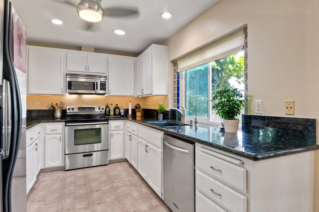 944 Alyssum Road Carlsbad, CA 92011 - Photo 3 of 20 Recessed under cabinet lighting and fan.