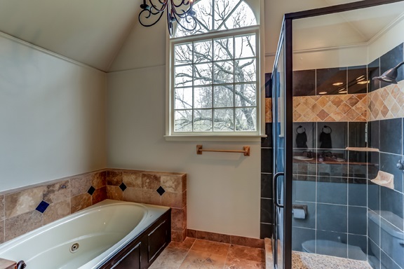 12206 Monterey Road Collierville, TN 38017 - Photo 12 of 25 Separate Jacuzzi tub & shower area with vaulted 12' ceiling and chandelier lighting.