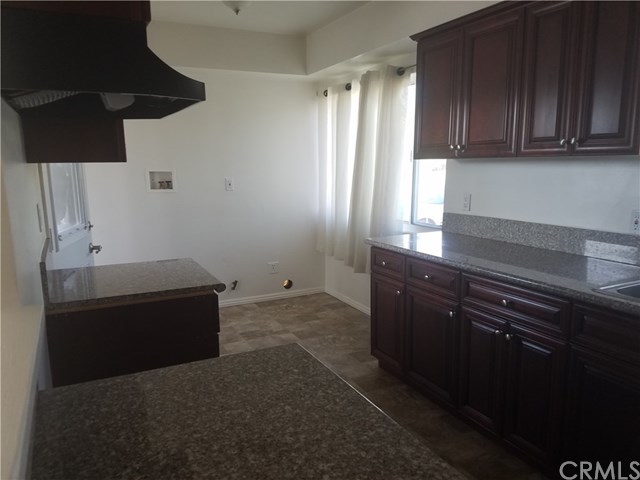 565 East Benbow Street Covina, CA 91722 - Photo 4 of 12 Updated kitchen with new floor, cabinets, granite counter tops and range hood. There is not a stove provided.