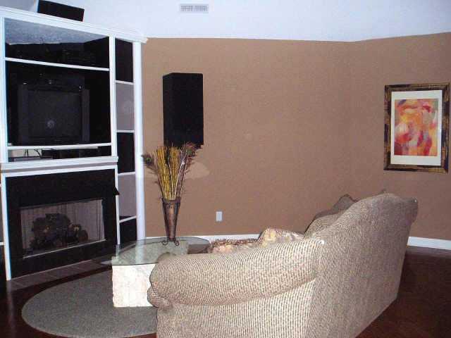 634 Portersville Road Atoka, TN 38004 - Photo 6 of 9 COZY DEN/MEDIA ROOM HAS HARDWOOD & TILE FLOORS, GAS FIREPLACE, AND CUSTOM BUILT-IN FOR HOME THEATRE