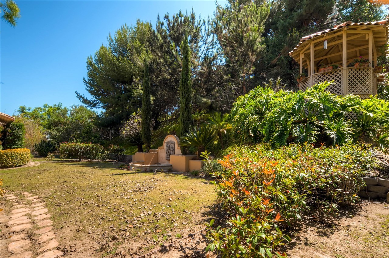 14888 Las Mananas Rancho Santa Fe, CA 92067 - Photo 12 of 25 This home features a large, private backyard with a water feature (not running due to the drought) and an elevated gazebo.