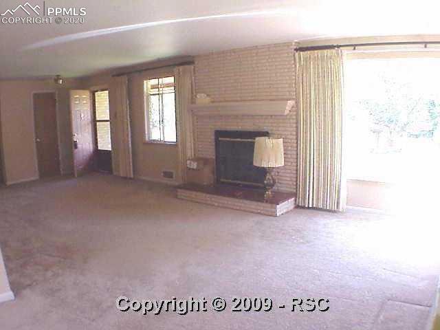 1320 Sunset Road Colorado Springs, CO 80909 - Photo 4 of 16 Spacious Living Room toward Front Door (with mail slot for secure mail delivery)